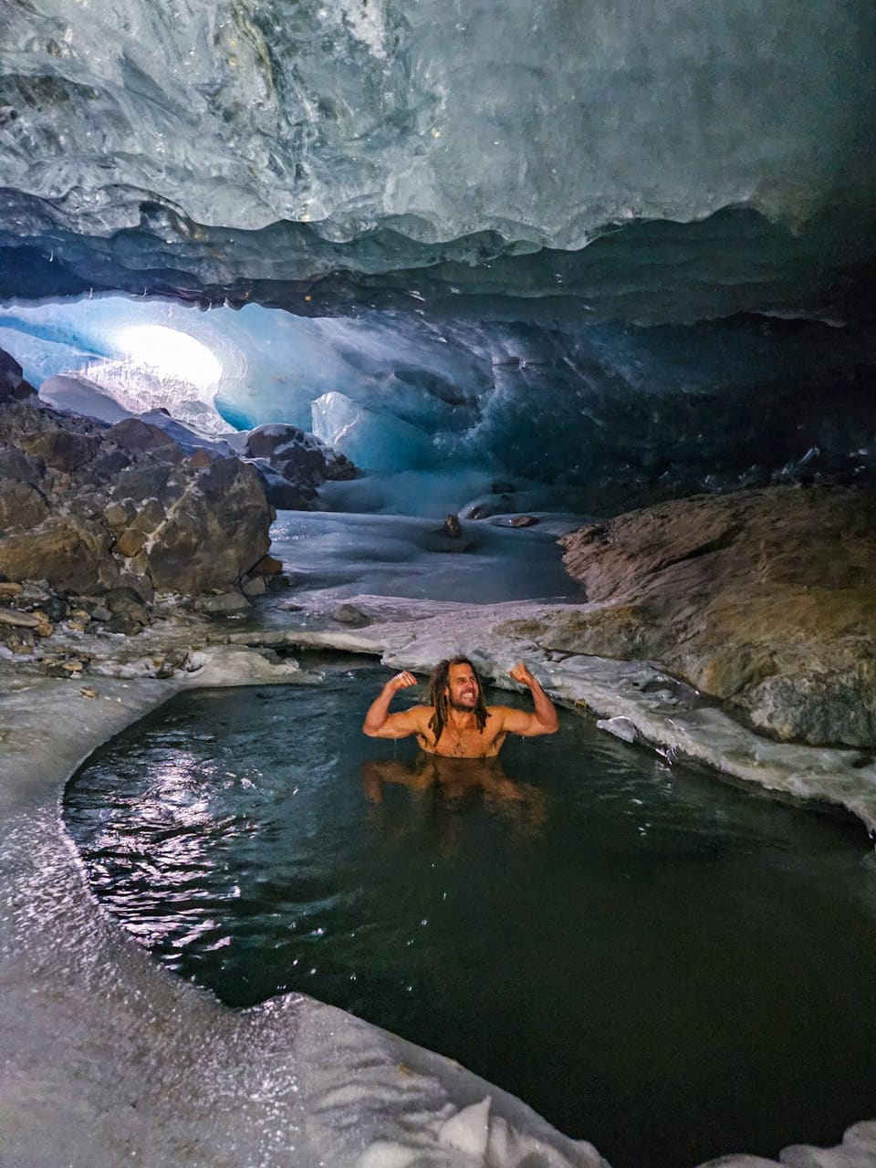Daniel Fetzy Fetz spannt in einem Eisbad unter einer Gletscherhöhle beide Arme an